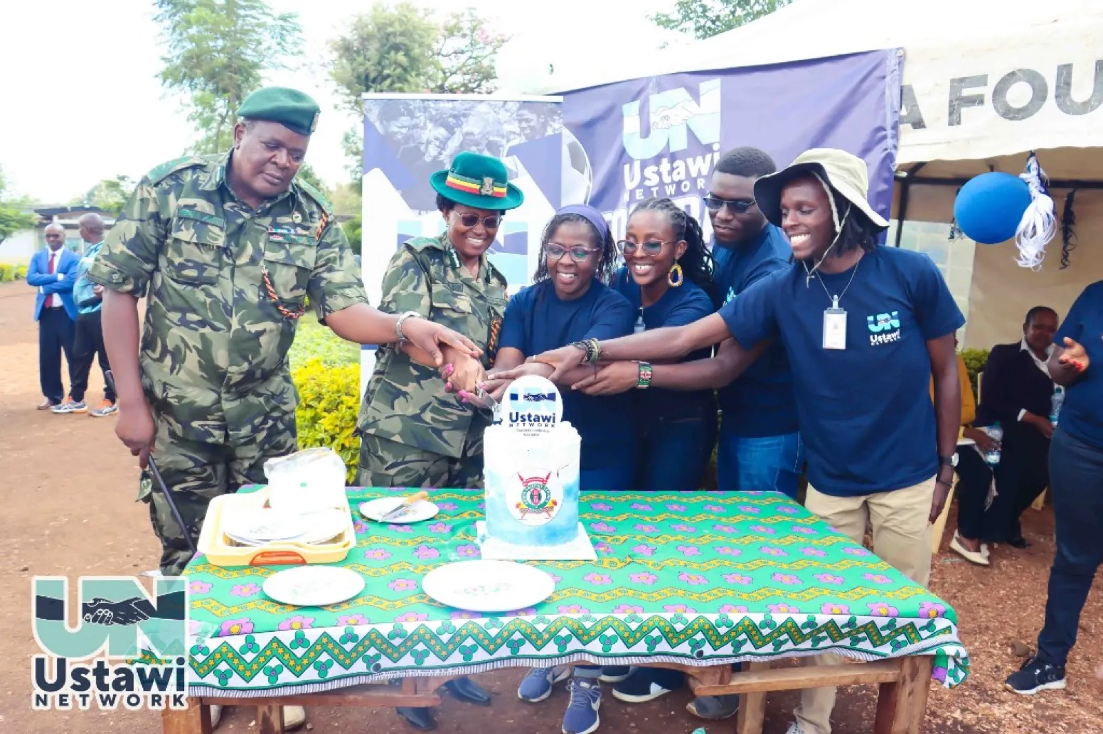 Joint cake-cutting at Ustawi Network launch with Kenya Prisons Service leaders.