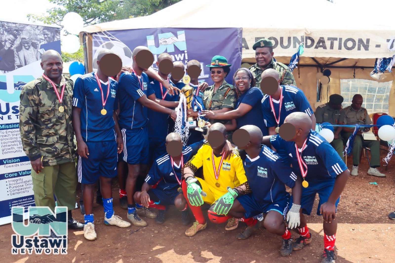 Tournament winners posing with trophy and Kenya Prisons Service partners.
